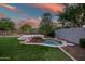 Lush backyard features a serene water feature and manicured lawn for outdoor enjoyment at 7775 E Fledgling Dr, Scottsdale, AZ 85255