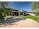 Expansive backyard features lush artificial grass, patio, and a luxurious spa with a rock waterfall feature at 7775 E Fledgling Dr, Scottsdale, AZ 85255