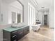 Elegant primary bathroom boasting a modern vanity, stylish bathtub, and abundant natural light at 7775 E Fledgling Dr, Scottsdale, AZ 85255