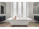 Elegant bathroom featuring a soaking tub, double vanities, and natural light at 7775 E Fledgling Dr, Scottsdale, AZ 85255