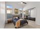 Bright bedroom features a neutral palette, carpet flooring, and mirrored closet at 7775 E Fledgling Dr, Scottsdale, AZ 85255