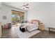 Bright bedroom showcasing a cozy bed, stylish decor, and a sunlit outdoor patio area at 7775 E Fledgling Dr, Scottsdale, AZ 85255