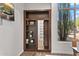 Custom wood bookcase featuring a hidden doorway at 7775 E Fledgling Dr, Scottsdale, AZ 85255
