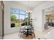 Bright breakfast nook features a modern chandelier and a large window overlooking the landscaped backyard at 7775 E Fledgling Dr, Scottsdale, AZ 85255
