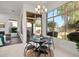Cozy dining area with a view of the outdoor patio, an outdoor BBQ and a small fireplace at 7775 E Fledgling Dr, Scottsdale, AZ 85255