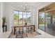 Elegant dining room features an oversized window, stylish table decor, and an open patio access at 7775 E Fledgling Dr, Scottsdale, AZ 85255