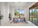 Bright dining room showcasing large windows, stylish lighting, and access to the backyard at 7775 E Fledgling Dr, Scottsdale, AZ 85255