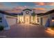 Eye-catching front exterior with symmetrical curb appeal and a circular window above the front door at 7775 E Fledgling Dr, Scottsdale, AZ 85255