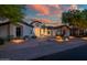 Beautiful front exterior displaying meticulous landscaping, rock features, and desert foliage at 7775 E Fledgling Dr, Scottsdale, AZ 85255
