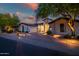 The front exterior of the home shows a circular window feature and manicured desert landscaping at 7775 E Fledgling Dr, Scottsdale, AZ 85255