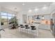 Bright kitchen with a large island, seating, modern appliances, and a dining area with backyard views at 7775 E Fledgling Dr, Scottsdale, AZ 85255