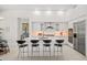 Spacious kitchen with an island, seating, modern appliances, and open layout with plenty of natural light at 7775 E Fledgling Dr, Scottsdale, AZ 85255