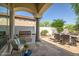 Covered outdoor kitchen and patio area with barbeque, seating, and well maintained landscaping at 7775 E Fledgling Dr, Scottsdale, AZ 85255