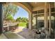 Elegant outdoor living space with comfortable seating, lush greenery, and a beautiful stone patio at 7775 E Fledgling Dr, Scottsdale, AZ 85255