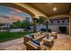 Covered patio overlooking artificial lawn, pool and spa, perfect for entertaining at 7775 E Fledgling Dr, Scottsdale, AZ 85255