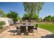 Outdoor patio features dining table and chairs, complimented by mature trees and landscaping at 7775 E Fledgling Dr, Scottsdale, AZ 85255