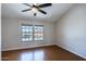 Bedroom with wood floor, vaulted ceiling, and two windows providing natural light at 8111 W Wacker Rd # 94, Peoria, AZ 85381