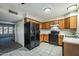 Open kitchen floor plan with tile floor, wooden cabinets, and black appliances at 8111 W Wacker Rd # 94, Peoria, AZ 85381