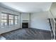 An open living area features a fireplace, carpet flooring, and stairs to the next level at 8111 W Wacker Rd # 94, Peoria, AZ 85381