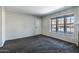 A carpeted living area has a window, a front door, and neutral wall color at 8111 W Wacker Rd # 94, Peoria, AZ 85381