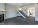 Inviting living room showcasing a cozy fireplace, staircase, and plush carpet at 8111 W Wacker Rd # 94, Peoria, AZ 85381