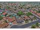 A neighborhood view of many single-Gathering homes, lush greenery, and community streets from an aerial perspective at 927 N Somerset Cir, Mesa, AZ 85205