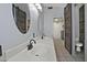 Bright bathroom featuring a double sink vanity, stylish mirrors, and rustic sliding barn door at 927 N Somerset Cir, Mesa, AZ 85205
