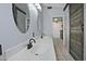 Bright bathroom featuring a double sink vanity, stylish mirrors, and rustic sliding barn door at 927 N Somerset Cir, Mesa, AZ 85205