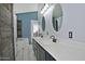 Bright bathroom featuring a double sink vanity, stylish mirrors, and rustic sliding barn door at 927 N Somerset Cir, Mesa, AZ 85205
