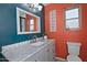 Well-lit bathroom with modern sink, marble countertop and colorful accent walls at 927 N Somerset Cir, Mesa, AZ 85205