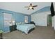 Spacious main bedroom with plush carpet flooring, ceiling fan, and large windows offering natural light at 927 N Somerset Cir, Mesa, AZ 85205