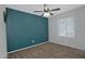 Bedroom featuring a ceiling fan, a large dark accent wall and neutral carpeting at 927 N Somerset Cir, Mesa, AZ 85205
