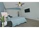 Comfortable bedroom featuring plush carpet flooring, a ceiling fan, and large windows offering natural light at 927 N Somerset Cir, Mesa, AZ 85205
