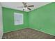 Bedroom with carpeted floors, ceiling fan, and a window for natural light at 927 N Somerset Cir, Mesa, AZ 85205