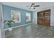 Sunlit bonus room with tiled floors, a ceiling fan, and shelving, perfect for a home office or sitting area at 927 N Somerset Cir, Mesa, AZ 85205
