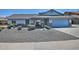 Charming single-story home features a two-car garage and low-maintenance desert landscaping in the front yard at 927 N Somerset Cir, Mesa, AZ 85205