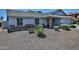 Lovely single-story home showcasing desert landscaping and brick accents, set back from the street at 927 N Somerset Cir, Mesa, AZ 85205