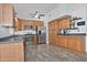 Bright kitchen featuring stainless steel appliances, wooden cabinetry, and tile floors at 927 N Somerset Cir, Mesa, AZ 85205