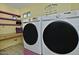 Laundry room featuring modern washer and dryer units with ample counter space at 927 N Somerset Cir, Mesa, AZ 85205