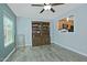 Charming living room featuring wood-look tile flooring, a ceiling fan and a stylish built-in hutch at 927 N Somerset Cir, Mesa, AZ 85205