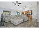 Cozy living room featuring tile flooring, a comfortable sectional sofa, and a ceiling fan at 927 N Somerset Cir, Mesa, AZ 85205