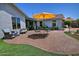 Outdoor patio with brick flooring, seating, a grill and a bright umbrella for shade at 927 N Somerset Cir, Mesa, AZ 85205