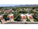 Aerial view of homes with red tile roofs, lush greenery, mountain views, and well-maintained landscaping at 9322 E Jenan Dr, Scottsdale, AZ 85260