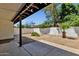 Well-maintained backyard with gravel landscaping, a covered patio, and privacy walls at 9322 E Jenan Dr, Scottsdale, AZ 85260
