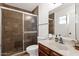 Well-maintained bathroom featuring a glass-enclosed shower, a marble vanity, and chrome fixtures at 9322 E Jenan Dr, Scottsdale, AZ 85260