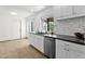 Bright kitchen with stainless steel appliances, white cabinets, gray counter tops, and a window with a view at 9322 E Jenan Dr, Scottsdale, AZ 85260