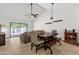 Bright living room with high ceilings, a dining area, a ceiling fan, and sliding glass doors leading to the patio at 9322 E Jenan Dr, Scottsdale, AZ 85260