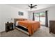 Inviting main bedroom featuring a king bed, a modern nightstand, and sliding door to backyard at 9322 E Jenan Dr, Scottsdale, AZ 85260
