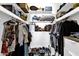 Organized walk-in closet with shelving, hanging rods, and shoe racks maximizing space at 9322 E Jenan Dr, Scottsdale, AZ 85260