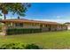 Well-maintained yard of brick home featuring lush greenery and privacy hedge at 1004 E Gemini Dr, Tempe, AZ 85283